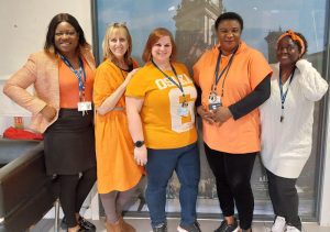 Staff from Muamba House, including Dawn Thornber, dressed in orange.