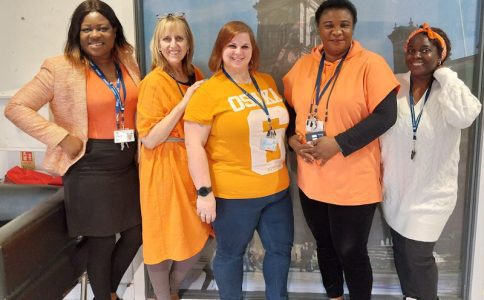 Staff from Muamba House, including Dawn Thornber, dressed in orange.