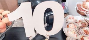 The figure 10 on a party table of cakes.